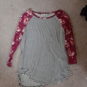 A stripped shirt with flower sleeves.